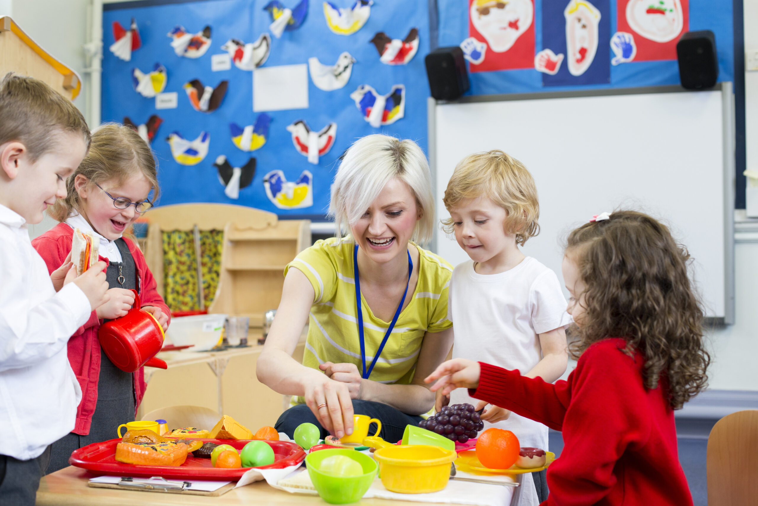 Nursery Teacher, with Nursery aged children in a classroom